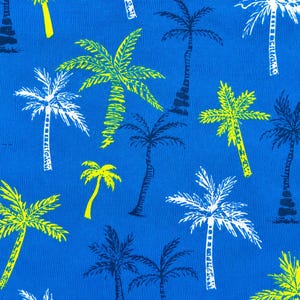 May include: A vibrant blue fabric featuring a repeating pattern of stylized palm trees. The palm trees are rendered in shades of white, yellow, and dark blue, creating a tropical and summery aesthetic. The design is suitable for various applications.
