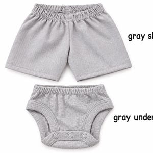 May include: A pair of light gray shorts with an elastic waistband and a pair of light gray underwear with three snap closures at the bottom. The text "gray shorts" is positioned next to the shorts and "gray underwear" next to the underwear.