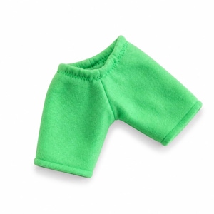 May include: A bright green, short-sleeved shirt made of a soft fabric. The shirt has a rounded neckline and short sleeves. The edges of the sleeves and neckline are finished with a rolled hem. The shirt is designed for a doll.