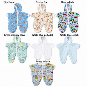 May include: Seven hooded baby sleep sacks with front zippers. Patterns include blue bear, cream fox, blue vehicle, green monkey cloud, white blue polkadot, white blue check, and gray vehicle. Each garment features short sleeves and a rounded bottom.