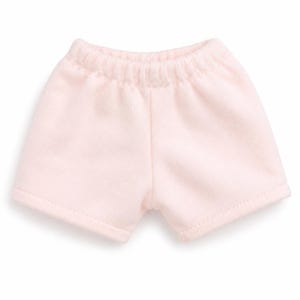 May include: A pair of light pink shorts featuring a soft, fleece-like texture and an elasticated waistband. The garment has a simple, pull-on design with straight-cut leg openings and a single vertical seam running down the centre front.
