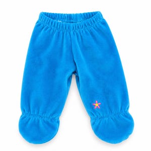 May include: Bright blue fleece pants with an elastic waistband and enclosed feet. The pants feature a small embroidered pink flower with a yellow center on the lower left leg and gathered fabric at the ankles for a secure fit.