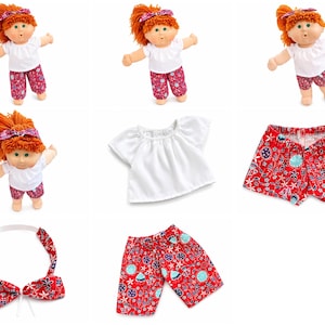May include: A doll with orange yarn hair wearing a white short-sleeved top and red floral print pants, shorts, or a headband. The set includes a white blouse, red patterned shorts, red patterned long pants, and a matching red floral headband.