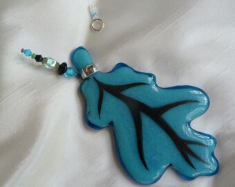 Fused sky and pale blue, stained glass, hand painted oak leaf suncatcher.