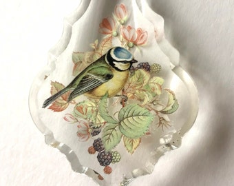 Blue tit sun catcher with roses and brambles.