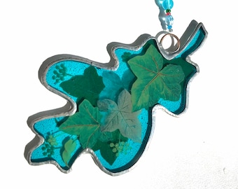 Sky blue stained glass oak leaf with ivy leaves.