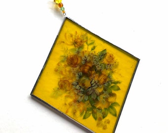 Yellow stained glass diamond sun catcher with roses and honeysuckle.