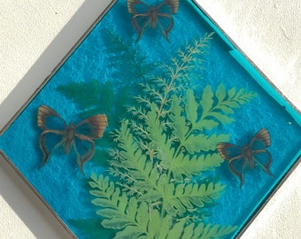 Sky blue stained glass diamond sun catcher with blue butterflies and ferns.