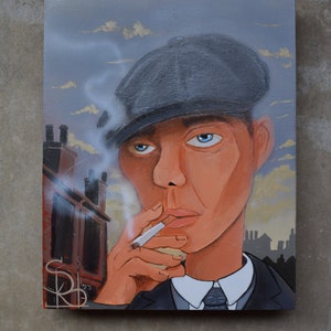 May include: An oil painting of a man in a grey flat cap, smoking a cigarette. The artwork features a man in a suit with a white shirt and tie. The background depicts a cityscape with chimneys and a cloudy sky. The artist's initials and the year '23 are visible.