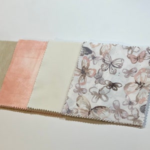May include: Four fabric swatches, one beige, one peach, one white, and one white with a watercolor butterfly print.