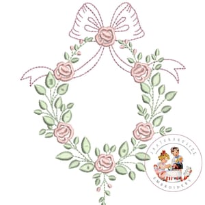 May include: A pink and green floral wreath with a pink bow in the center. The wreath is surrounded by a white background. The text "Jack and Jill Embroidery" is in a circle at the bottom of the image.