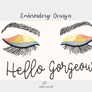 May include: Embroidery design featuring a pair of closed eyes with colourful eyeshadow and the text "Hello Gorgeous".