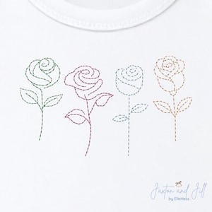 May include: White onesie with four embroidered roses in green, burgundy, blue, and brown. Each rose is a different color and has a stem and leaves. The design is simple and elegant, perfect for a baby.