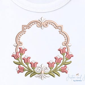 May include: Embroidered floral design featuring pink tulips and green leaves, arranged in a semi-circle around a decorative frame. The frame is a light brown color with a beaded border and ornate details. The design is on a white background.