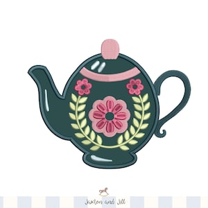 May include: Embroidered teal teapot with pink and yellow floral design. The teapot features a pink lid and handle, with a central flower and leaf accents. A decorative item for kitchen or tea-themed decor.