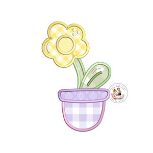 May include: A yellow flower with a gingham pattern in a purple pot with a gingham pattern. The flower has a green stem and leaf.