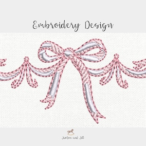 Könnte beinhalten: Ein Stickdesign mit einer rosa Schleife mit weißen Akzenten und dekorativen Verzierungen. Der Text "Embroidery Design" befindet sich über der Schleife. Das Design befindet sich auf einem strukturierten, cremefarbenen Hintergrund.