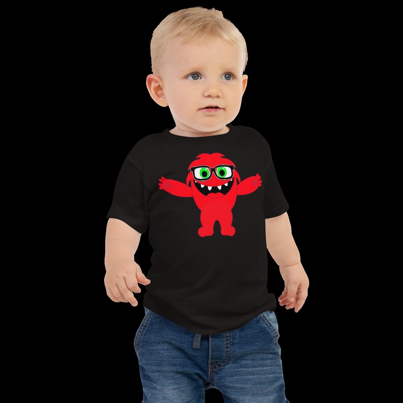 May include: A black toddler t-shirt with a red monster wearing glasses graphic. The monster has green eyes and a big smile.