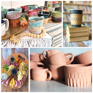 May include: A collection of handmade ceramic mugs in various colors and patterns, including a blue and white mug with a brown glaze, a purple and brown mug with a speckled glaze, and a green and white mug with a floral design. The mugs are arranged on a wooden table with a white and blue striped tablecloth.