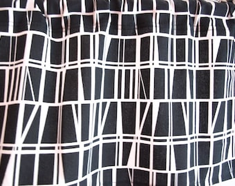 May include: Black and white patterned fabric, possibly for curtains or a similar home decor item. The design features a grid-like structure with irregular vertical and horizontal lines, creating a modern, geometric aesthetic. The fabric is tightly woven, suggesting durability.