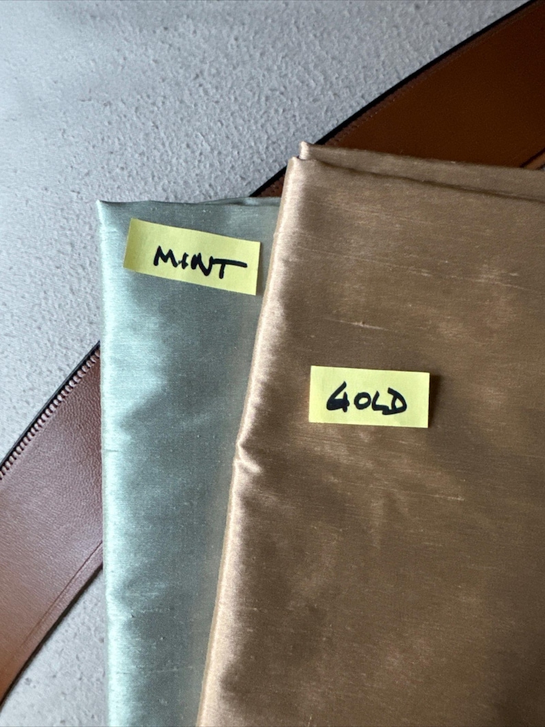 May include: Two fabric swatches, one mint green and one gold, with handwritten labels "MINT" and "GOLD" on them.