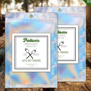 May include: Two iridescent fillable bags with a white label that reads "Madison's Bachelorette S'mores Kit" with the text "Let's Get Toasted" and the date "9.27.25". The bags are labeled "Custom 5x7 Fillable Bags".