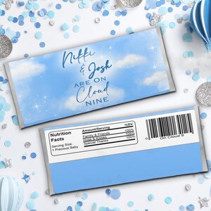 May include: Two candy bar wrappers with a blue sky and cloud design. The text on the wrappers reads "Niffe & Josh are on Cloud Nine." The wrappers are surrounded by blue and silver confetti and decorative elements.