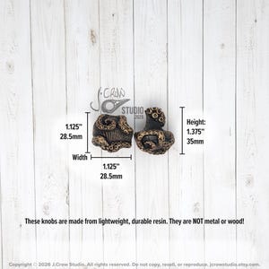 The knobs are 1.125 inches wide and 1.375 inches tall.