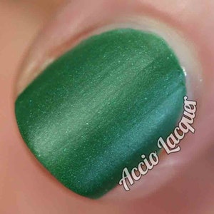 Against All Logic Nail Polish - matte green with blue sparkle