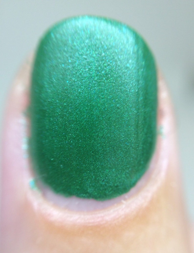 Against All Logic Nail Polish matte green with blue sparkle image 3