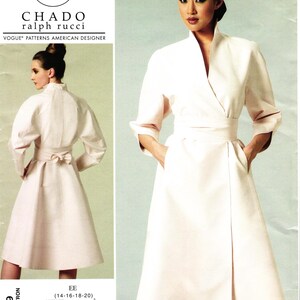 May include: A sewing pattern envelope for a Chado Ralph Rucci Vogue Patterns American Designer coat. The design features a light-colored, knee-length wrap coat with three-quarter length sleeves, a high collar, a waist tie, and side pockets.