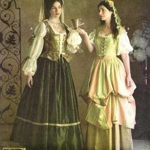 May include: Two floor-length dresses labeled A and B. Dress A features a dark green skirt, a gold bodice with front lacing, and sheer cream sleeves. Dress B features a light green and peach striped skirt, a light green bodice with lacing, and cream sleeves.