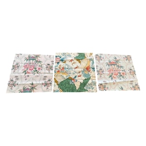 May include: Three fabric squares with floral and Asian-inspired patterns. One shows pink roses and a pagoda, another has fans and figures, and the third mirrors the first. The fabrics have a light background with colourful details.