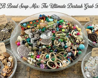 May include: A large glass bowl filled with a 1 LB bead soup mix, surrounded by four smaller bowls containing assorted beads and charms. Text reads: 1 LB Bead Soup Mix: The Ultimate Destash Grab Bag, Vintage to Modern, Upcycled to Glass, Artisan Mix.