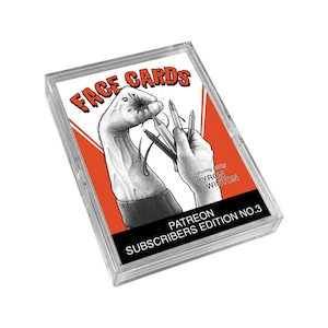 May include: A clear plastic box containing a deck of playing cards with a black and white illustration of a hand holding multiple pens. The box has a red background with the text "FACE CARDS" in white. The text "Featuring Art by BYRON WINTON" is in black on a white background. The text "PATREON SUBSCRIBERS EDITION NO. 3" is in white on a black background.