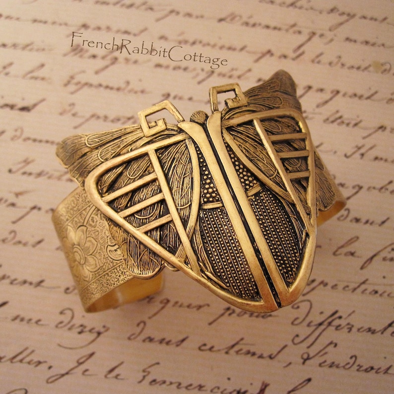 Gold tone Brass Cuff Bracelet with large Art Deco Style Butterfly / Moth. Band is stamped with a floral pattern. Jewelry Gift for women.