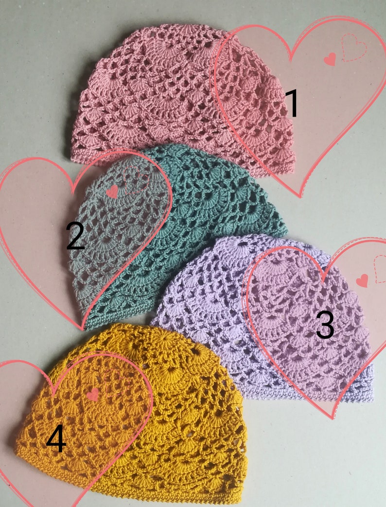 May include: Four crocheted hats in different colors: pink, green, purple, and yellow. The hats are arranged in a row, with the pink hat at the top and the yellow hat at the bottom.