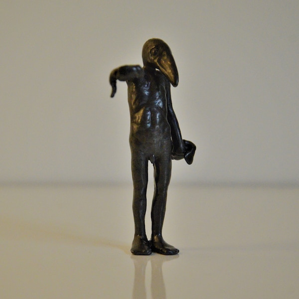Birdman offering a fish. Small bronze sculpture