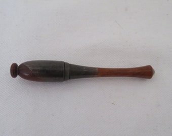 May include: A wooden and metal cigarette holder with a brown wooden tip and a silver metal middle section.