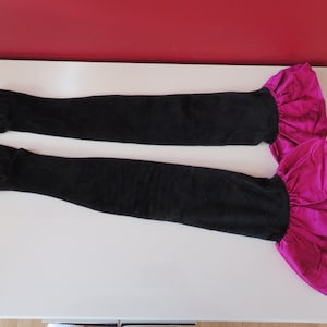 May include: A pair of long black gloves with pink ruffled cuffs.
