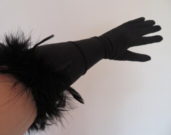 May include: Black long gloves with a feather trim at the wrist.