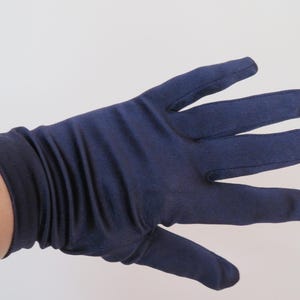 May include: A pair of long, navy blue satin gloves. The gloves are made of a smooth, silky fabric and have a fitted style.