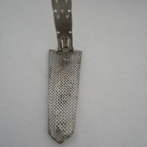 May include: A silver metal watch band with a mesh design and a clasp that folds up.