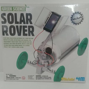 May include: A green science kit for kids called "Solar Rover" by Kids Labs 4M. The kit includes a solar panel, a motor, and a can to build a solar-powered rover. The box has a warning that the kit contains lead.