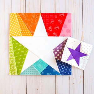 May include: A colorful patchwork quilt block featuring a white star with a rainbow of colors in the background. A smaller purple star block is also shown.