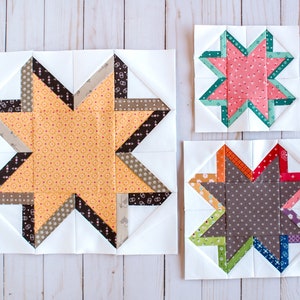 May include: Three star quilt blocks in varying sizes. The largest block features an orange star with brown and tan accents. The middle block has a pink star with teal accents. The smallest block has a multi-colored star.