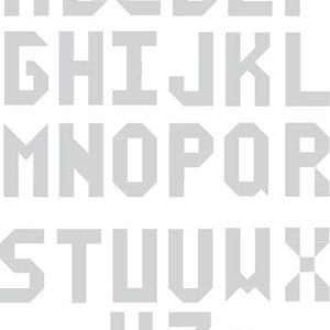 May include: A gray alphabet font with blocky, geometric letters. The letters are in uppercase and are arranged in three rows. The letters are all the same size and are evenly spaced.