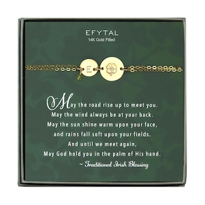 May include: A gold-filled bracelet with a shamrock charm and a letter 'E' charm. The bracelet comes in a green box with a traditional Irish blessing: "May the road rise up to meet you. May the wind always be at your back. May the sun shine warm upon your face, and rains fall soft upon your fields. And until we meet again, May God hold you in the palm of His hand. ~ Traditional Irish Blessing"