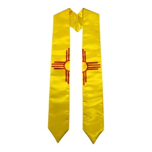 May include: Yellow graduation stole with the state of New Mexico's symbol, the Zia sun symbol, in red.