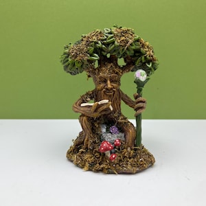 Miniatyrträd med ansikte och stav i älvträdgården